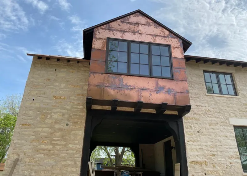 Copper metal panel facade on a stone building for Metal Roof Coating in Spring Hill