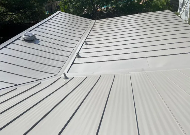 Solar attic fan installed on a metal roof for Roof Ventilation in Spring Hill